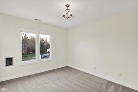 Bedroom at 434 Sheffield Court, Carmel, IN — Bright bedroom with large windows and fresh updates.