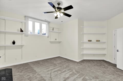 Bonus room at 434 Sheffield Court, Carmel, IN — Bright bonus room with extensive built-in shelving.