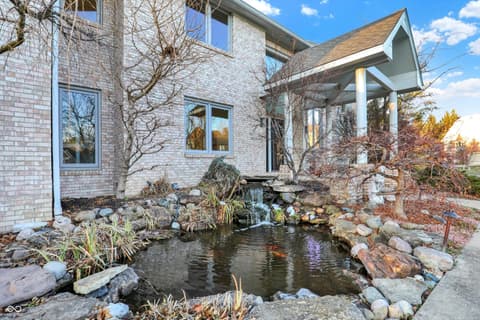 Front exterior at 434 Sheffield Court, Carmel, IN — Stunning front courtyard with tranquil koi pond.