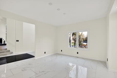 Family room at 434 Sheffield Court, Carmel, IN — Bright contemporary space with luxurious marble flooring.