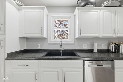 Kitchen at 15545 Hazel Dell Road, Noblesville, IN — Clean renovated kitchen with granite and stainless steel.
