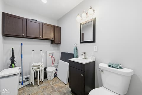 Primary bathroom at 15545 Hazel Dell Road, Noblesville, IN — Modern primary bath with dark vanity and updated fixtures.