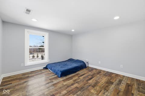 Bedroom at 15545 Hazel Dell Road, Noblesville, IN — Bright modern bedroom with hardwood floors and scenic views.