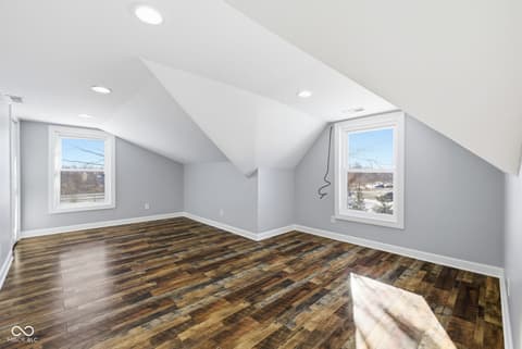 Bonus room at 15545 Hazel Dell Road, Noblesville, IN — Bright attic bonus room with hardwood floors and windows.
