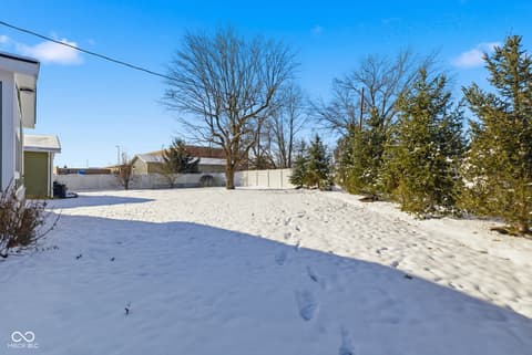 Yard at 15545 Hazel Dell Road, Noblesville, IN — Spacious fenced yard with mature trees and landscaping.