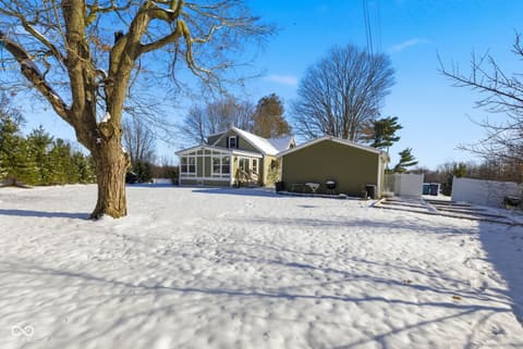 Front exterior at 15545 Hazel Dell Road, Noblesville, IN — Spacious open property with mature shade trees.