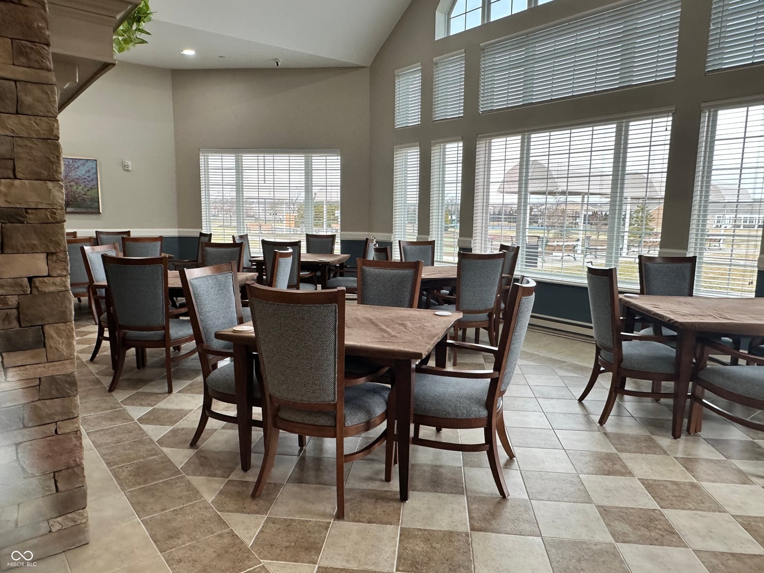 Spacious dining area with floor-to-ceiling views and natural light.