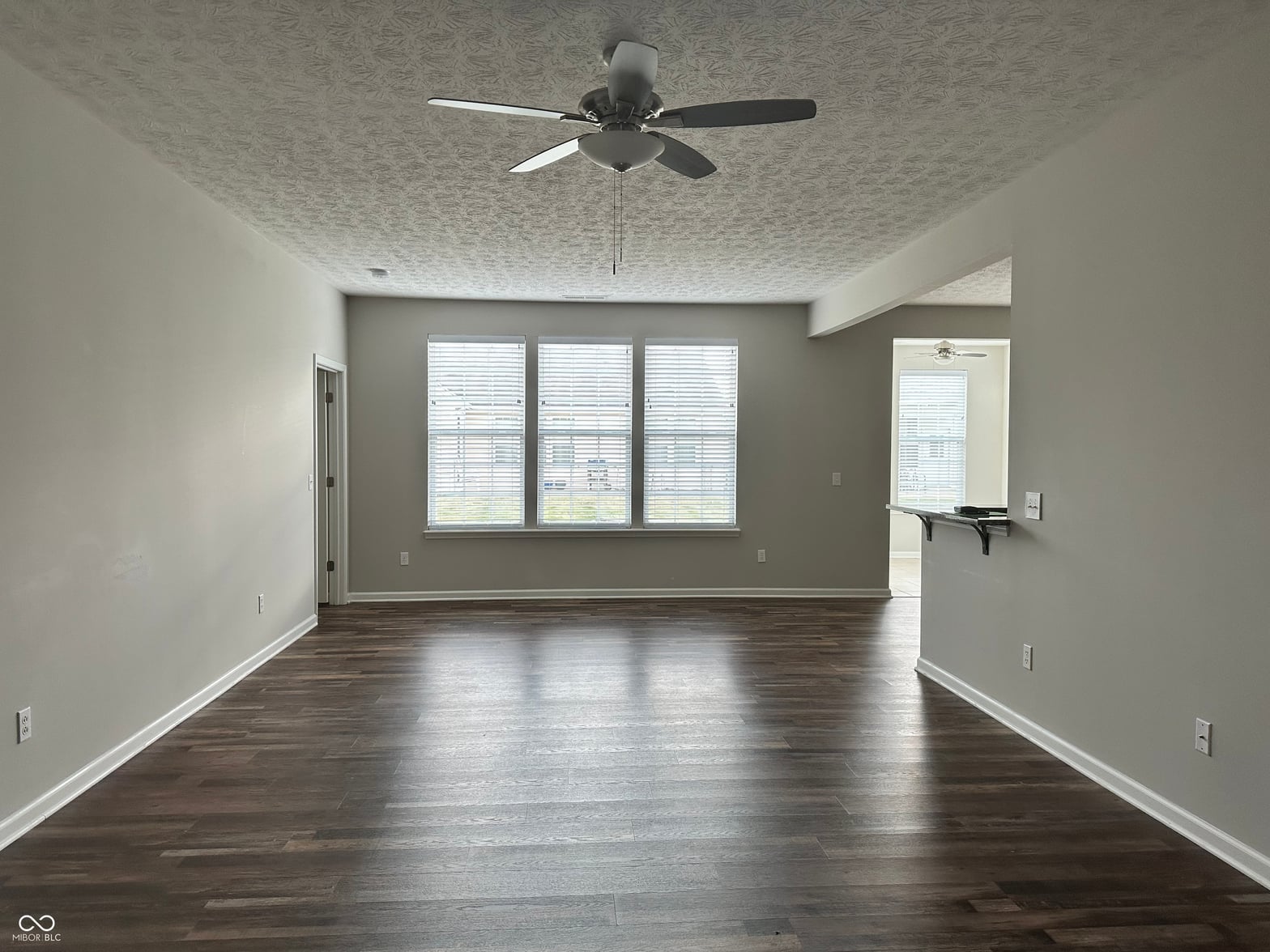 Bright, spacious living room with hardwood floors.