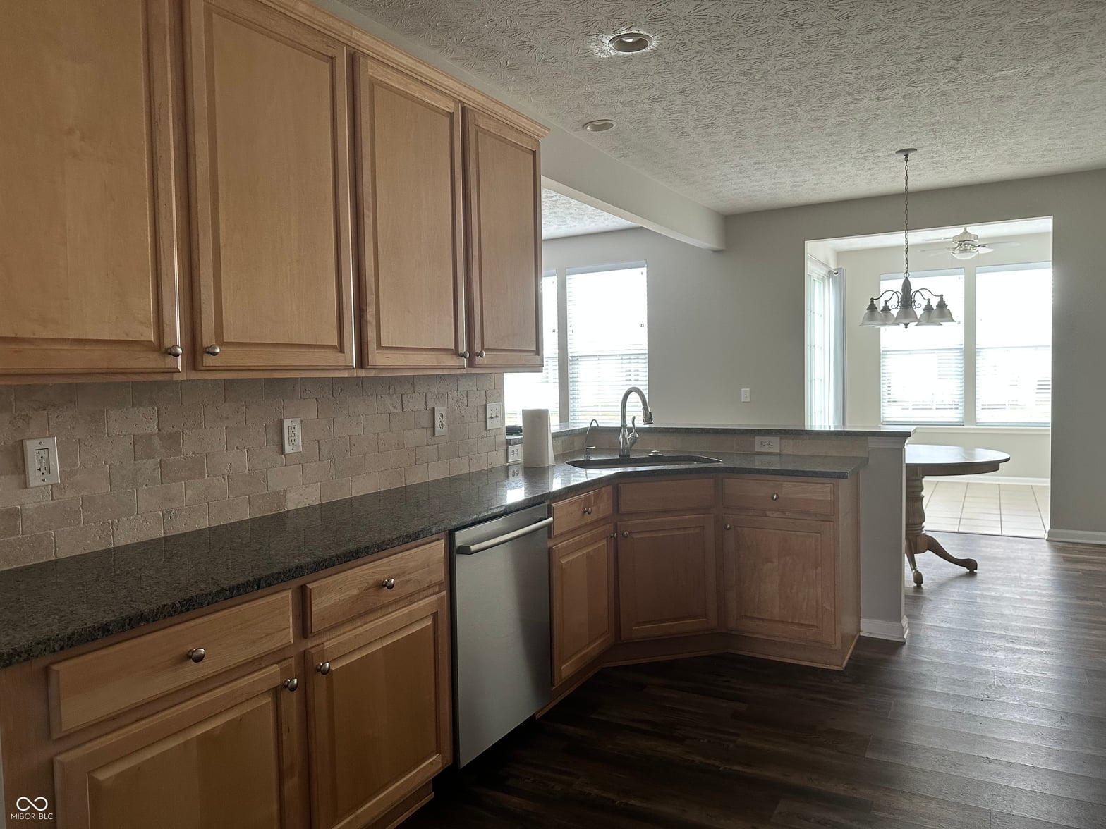 Updated kitchen with granite counters and island.
