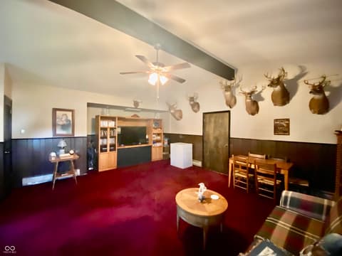 Family room at 1485 Westfield Road, Noblesville, IN — Spacious family room with fireplace and wainscoting details.