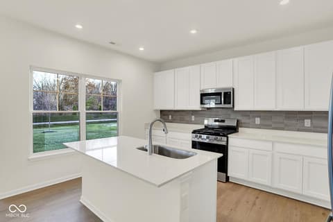 Kitchen at 1353 Mahoning Road, Sheridan, IN — Bright modern kitchen with island and backyard views.