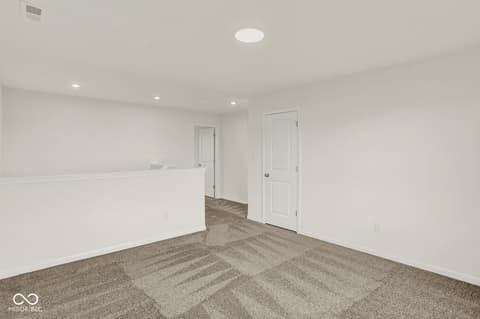 Basement at 1353 Mahoning Road, Sheridan, IN — Bright, finished basement with modern recessed lighting.