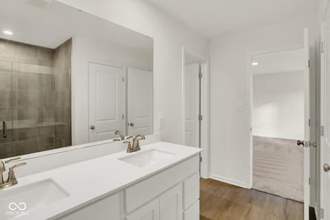 Primary bathroom at 1353 Mahoning Road, Sheridan, IN — Luxurious primary bath with dual vanity and walk-in shower.
