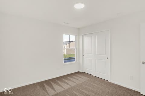 Bedroom at 1353 Mahoning Road, Sheridan, IN — Bright bedroom with new carpet and ample natural light.