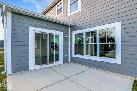 Backyard at 1353 Mahoning Road, Sheridan, IN — Modern backyard with expansive glass doors and patio.