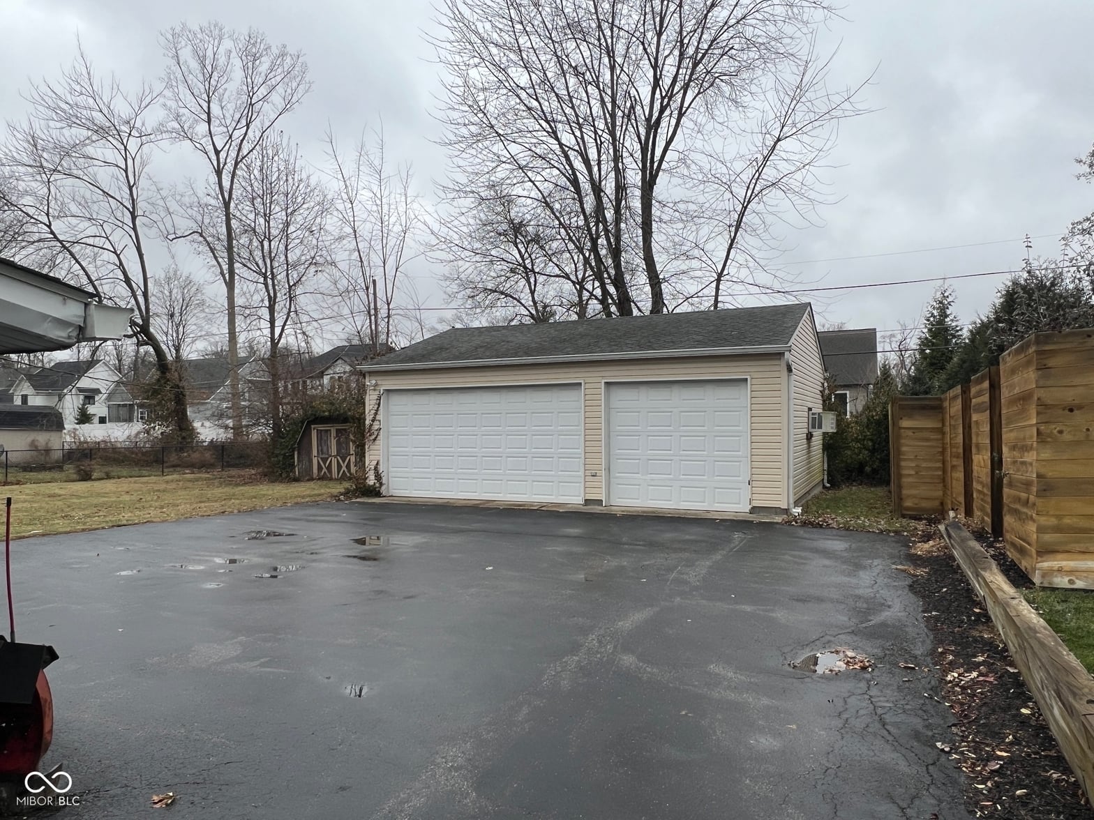 Spacious two-car detached garage with durable asphalt driveway.