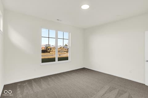 Bedroom at 19773 Highclere Lane, Sheridan, IN — Bright bedroom with expansive windows and modern finishes.