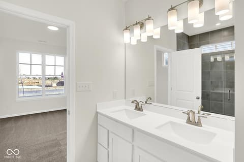 Primary bathroom at 19773 Highclere Lane, Sheridan, IN — Luxurious primary bath with dual vanity and walk-in shower.