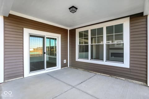 Outdoor living area at 19773 Highclere Lane, Sheridan, IN — Spacious modern patio with abundant natural light.
