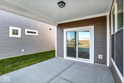 Outdoor living area at 19773 Highclere Lane, Sheridan, IN — Modern patio with direct access to finished yard.