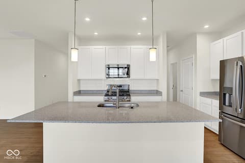 Kitchen at 19773 Highclere Lane, Sheridan, IN — Modern kitchen with expansive island and premium finishes.