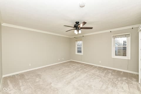 Family room at 13035 Wembly Road, Carmel, IN — Bright family room with crown molding and natural light.