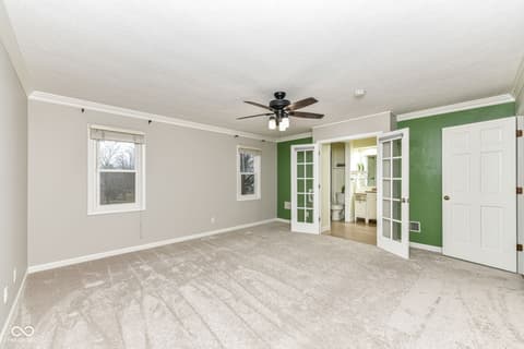 Primary bedroom at 13035 Wembly Road, Carmel, IN — Spacious primary bedroom with ensuite bathroom access.