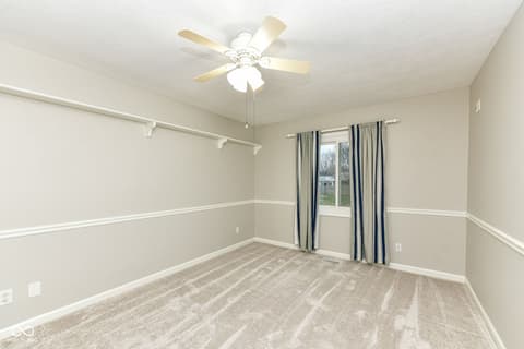 Bedroom at 13035 Wembly Road, Carmel, IN — Bright bedroom with chair rail and neutral palette.