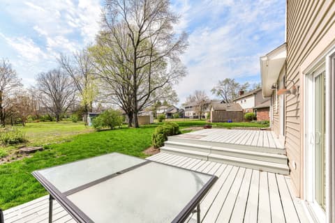 Outdoor living area at 13035 Wembly Road, Carmel, IN — Spacious composite deck overlooking mature, level yard.