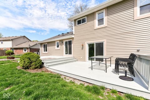 Backyard at 13035 Wembly Road, Carmel, IN — Spacious concrete patio with updated outdoor living space.