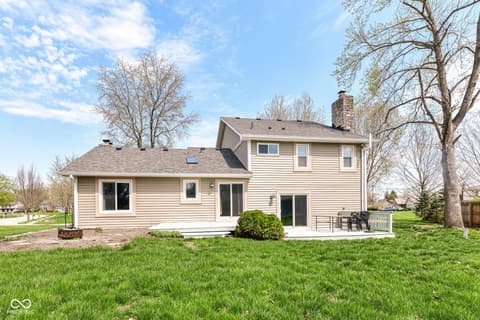 Backyard at 13035 Wembly Road, Carmel, IN — Spacious backyard with deck and mature landscaping.