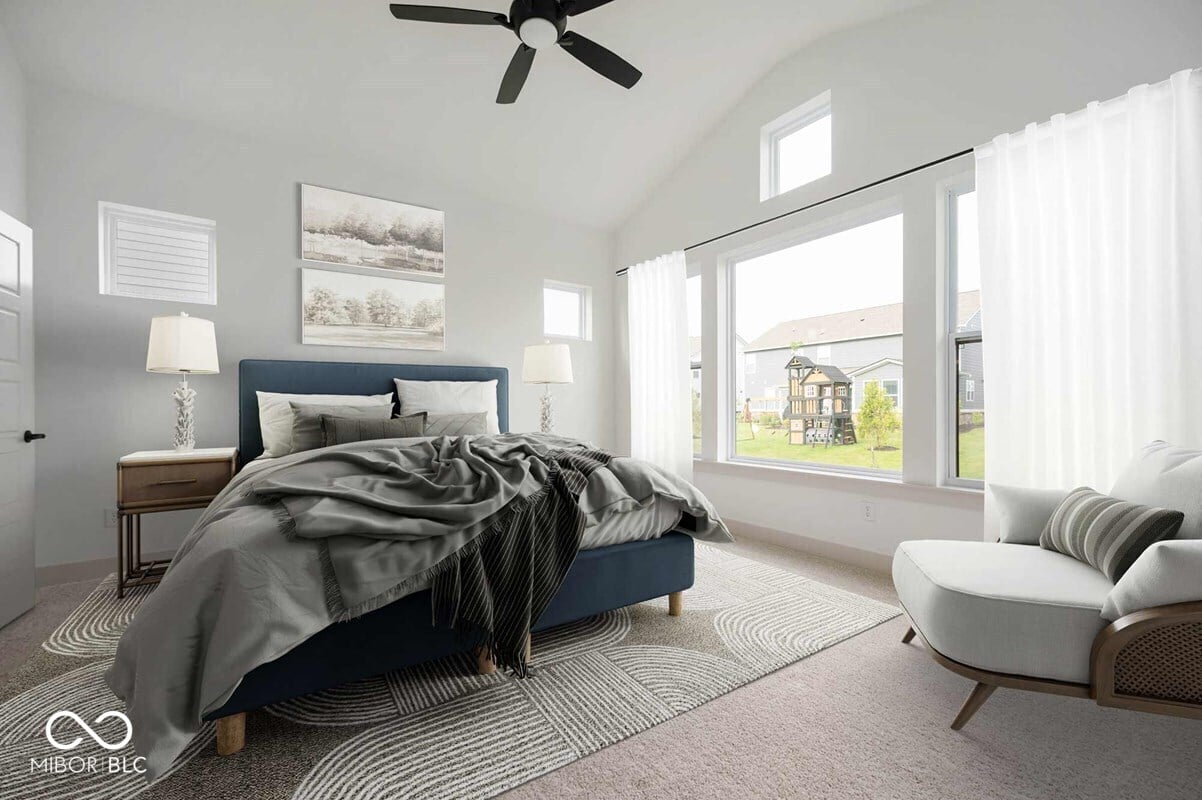 Bright, spacious primary bedroom with vaulted ceilings and views.