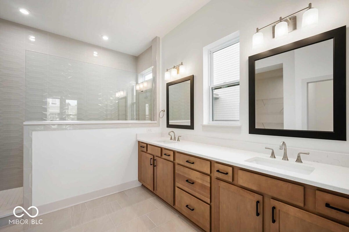 Spacious primary bath with dual vanity and walk-in shower.