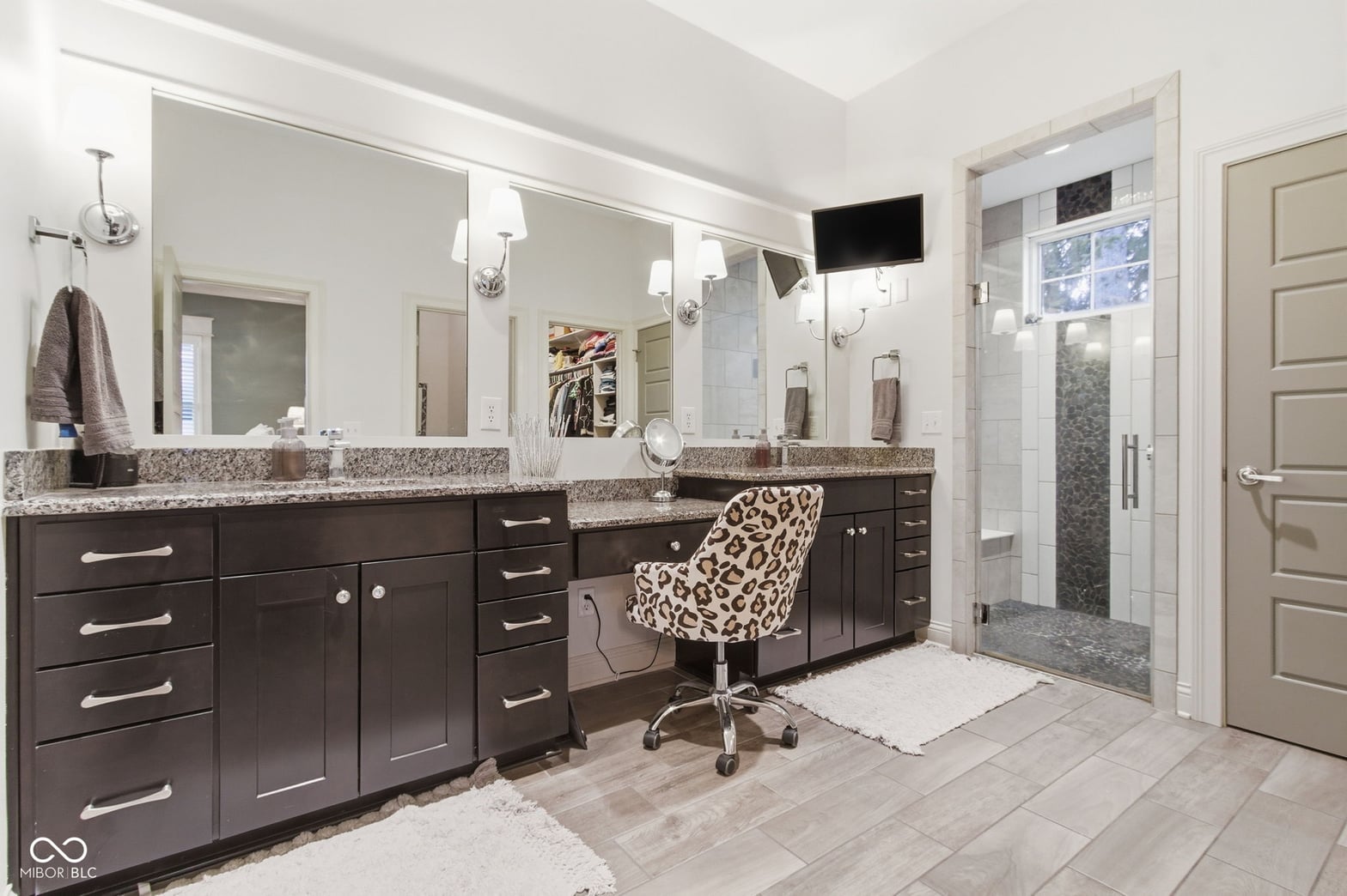 Luxurious primary bath with dual vanity and spa shower.