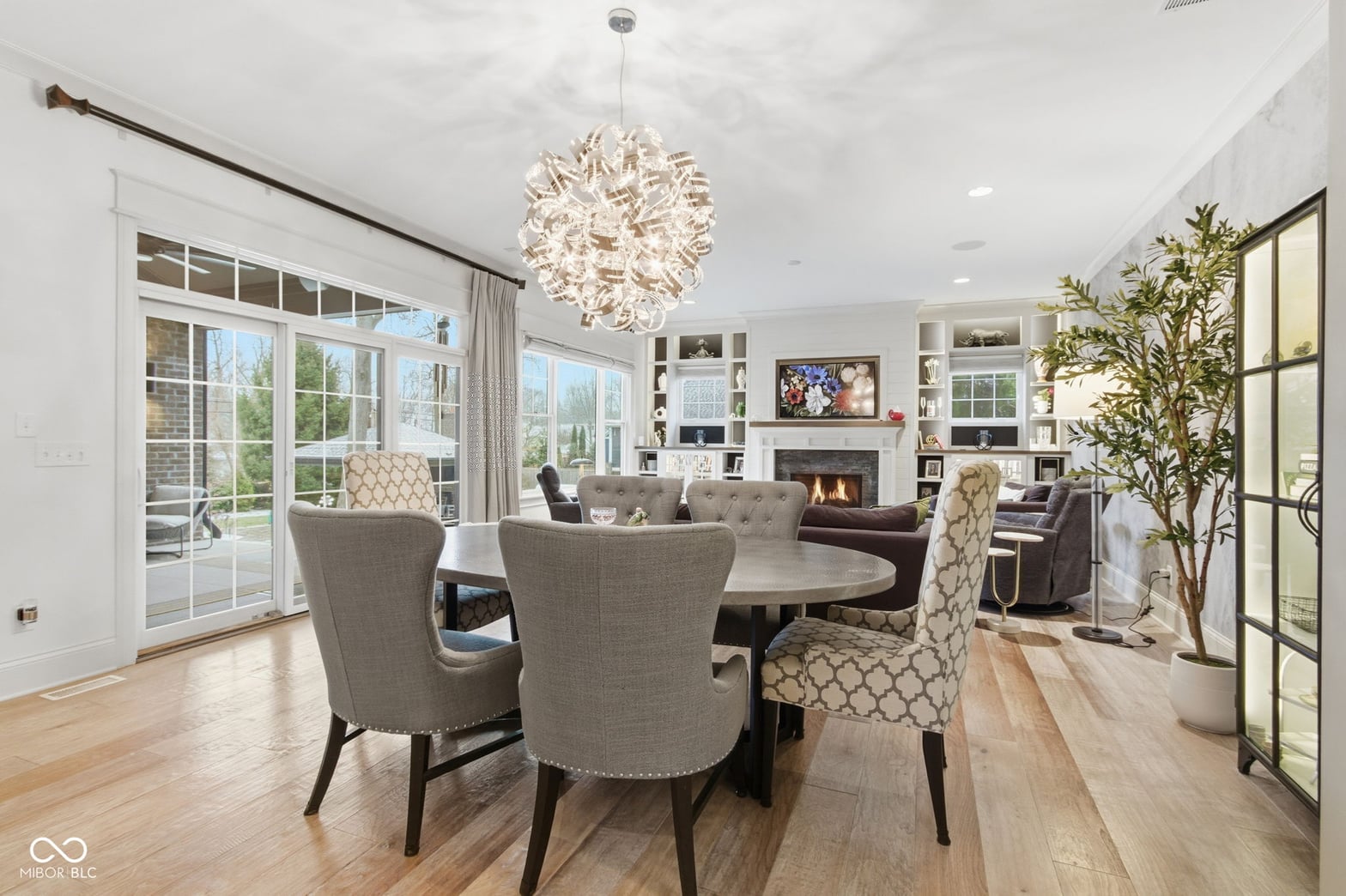Bright open living space with fireplace and built-ins.
