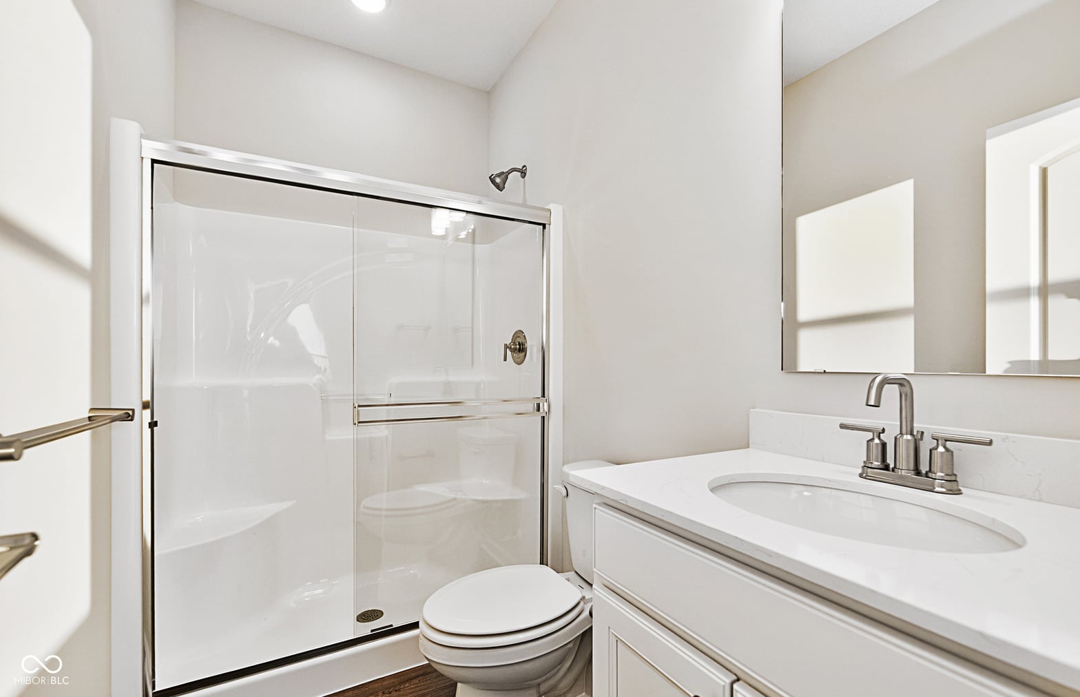 Clean, modern primary bath with frameless shower enclosure.