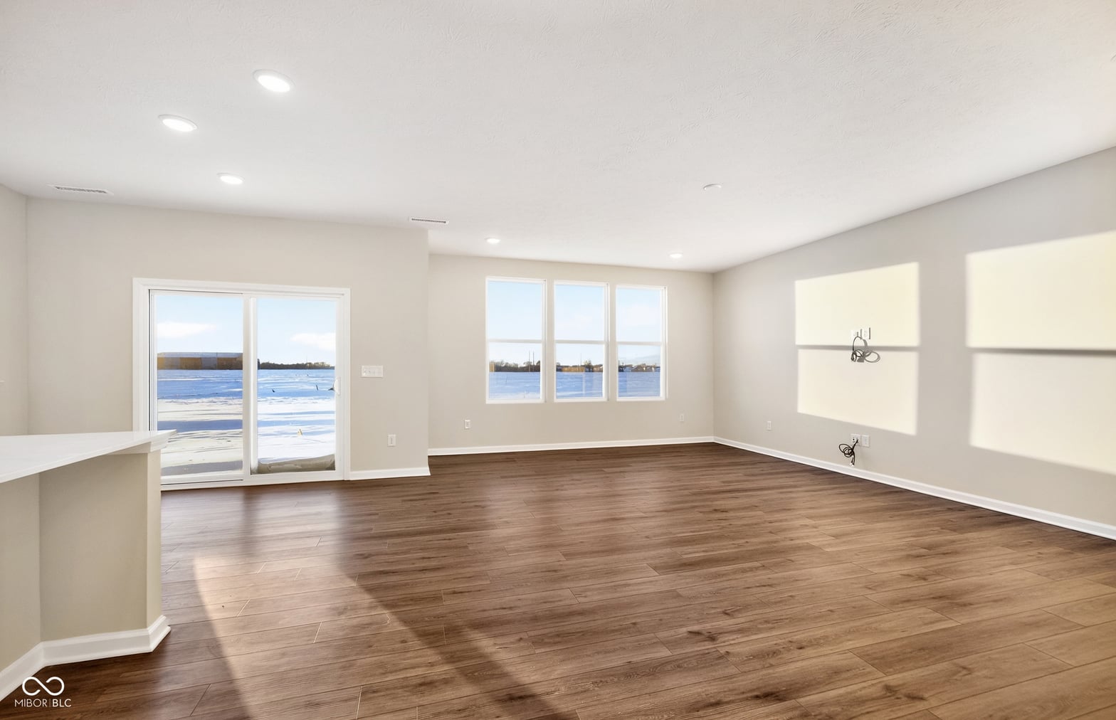 Waterfront living room with expansive views and modern finishes.