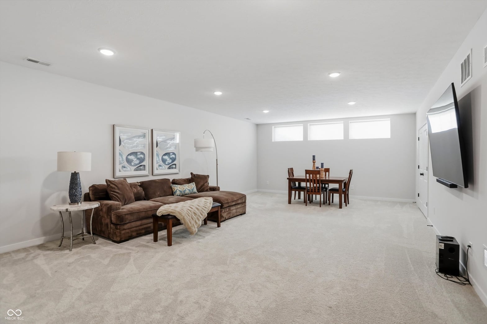 Spacious, bright finished basement with dining and entertainment zones.