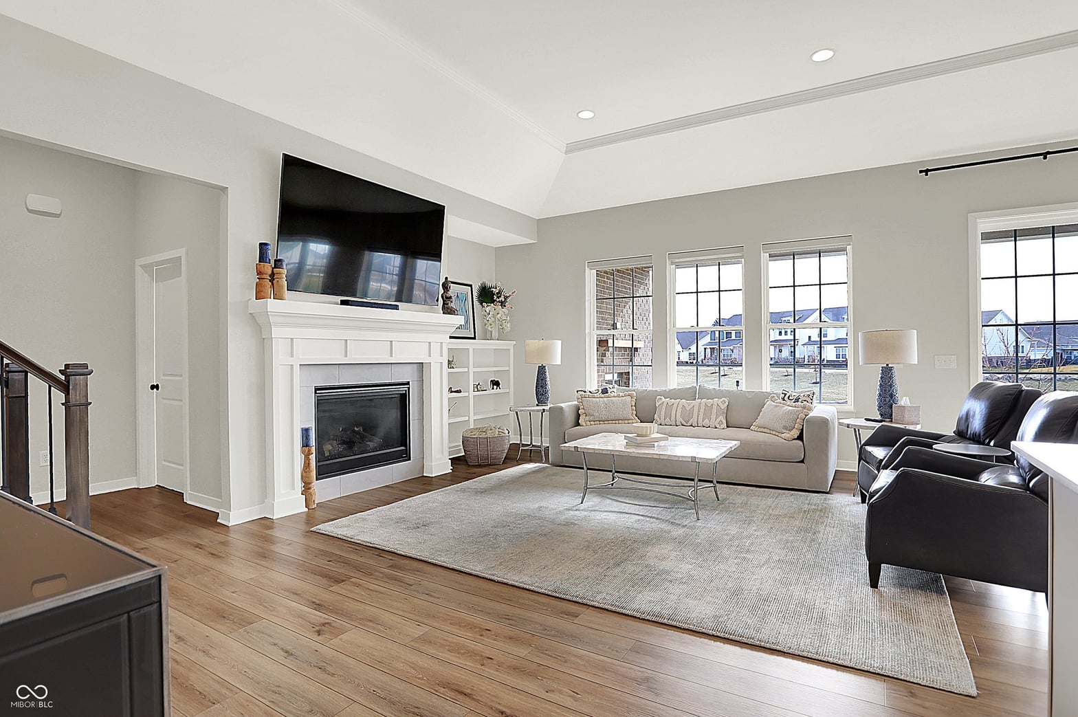 Bright living room with fireplace and expansive windows.