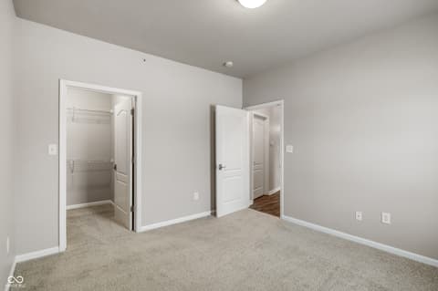 Primary bedroom at 12926 University Crescent, Carmel, IN — Spacious primary bedroom with generous walk-in closet.