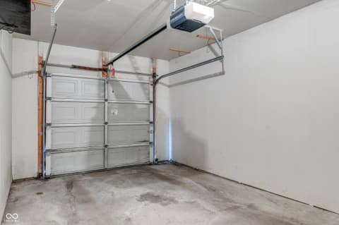 Garage at 12926 University Crescent, Carmel, IN — Clean two-car garage with automatic door opener installed.