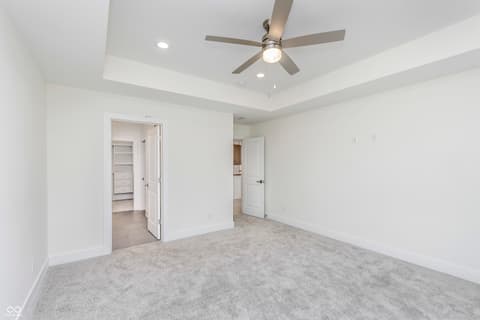Primary bedroom at 5866 Harbour Town Drive, Noblesville, IN — Spacious master suite with tray ceiling and walk-in closet.