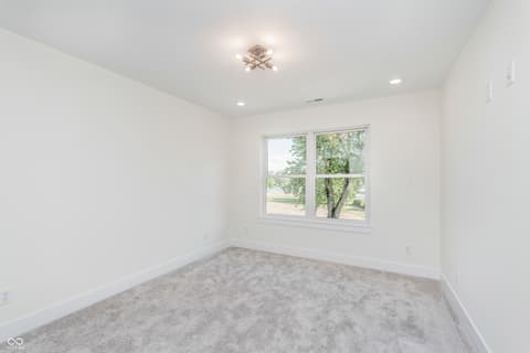 Bedroom at 5866 Harbour Town Drive, Noblesville, IN — Bright bedroom with large windows and new carpet flooring.