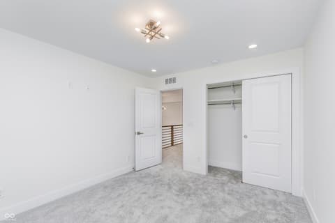 Primary bedroom at 5866 Harbour Town Drive, Noblesville, IN — Spacious primary bedroom with dual walk-in closets.