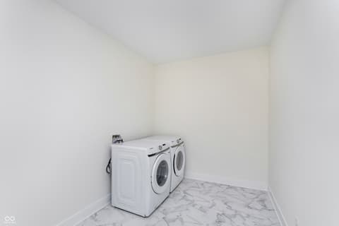 Laundry room at 5866 Harbour Town Drive, Noblesville, IN — Spacious modern laundry room with marble flooring.