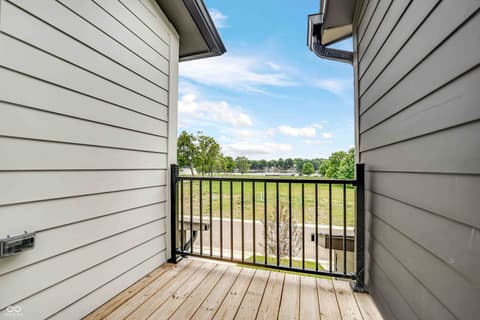 Outdoor living area at 5866 Harbour Town Drive, Noblesville, IN — Expansive deck with scenic open field views.