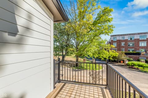 Outdoor living area at 5866 Harbour Town Drive, Noblesville, IN — Modern deck with mature trees and open yard views.