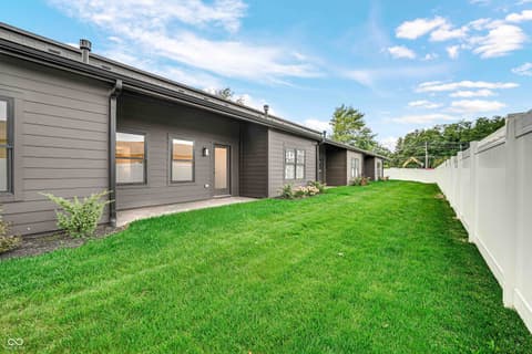 Backyard at 5866 Harbour Town Drive, Noblesville, IN — Spacious fenced backyard with modern contemporary home.