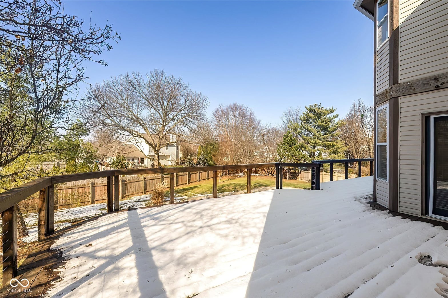 Expansive elevated deck with scenic wooded views.