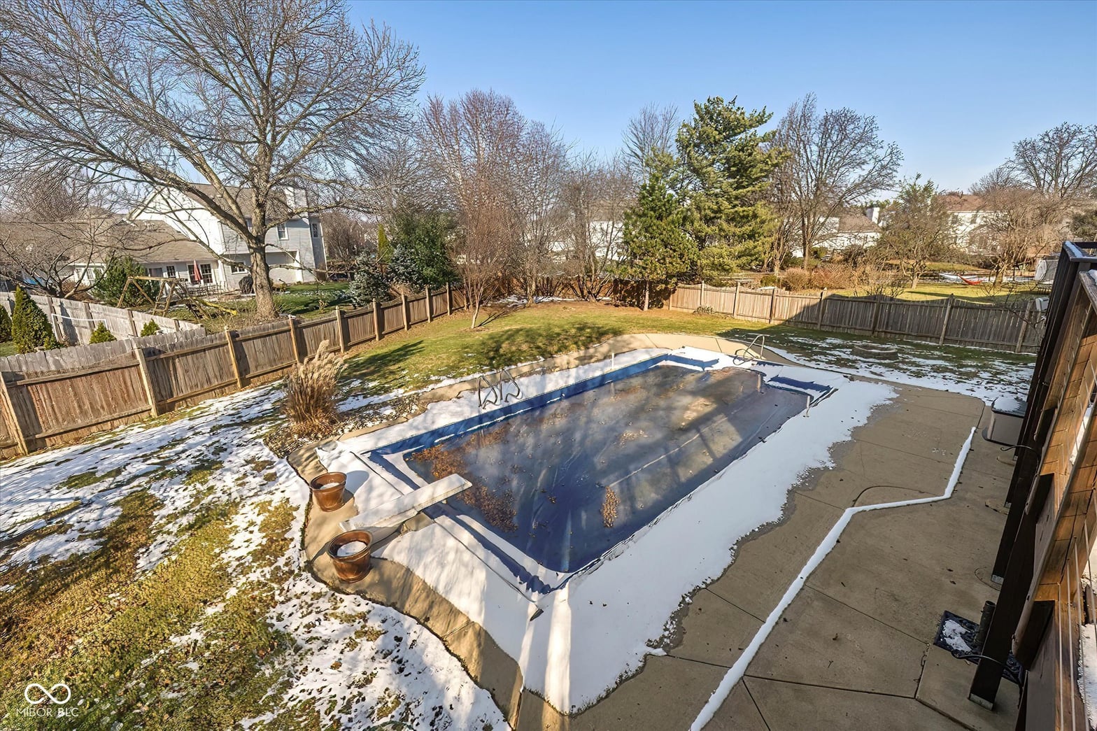In-ground pool with spacious fenced yard and mature landscaping.